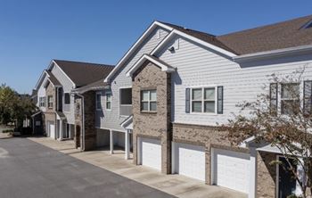 A row of houses with garages in front.